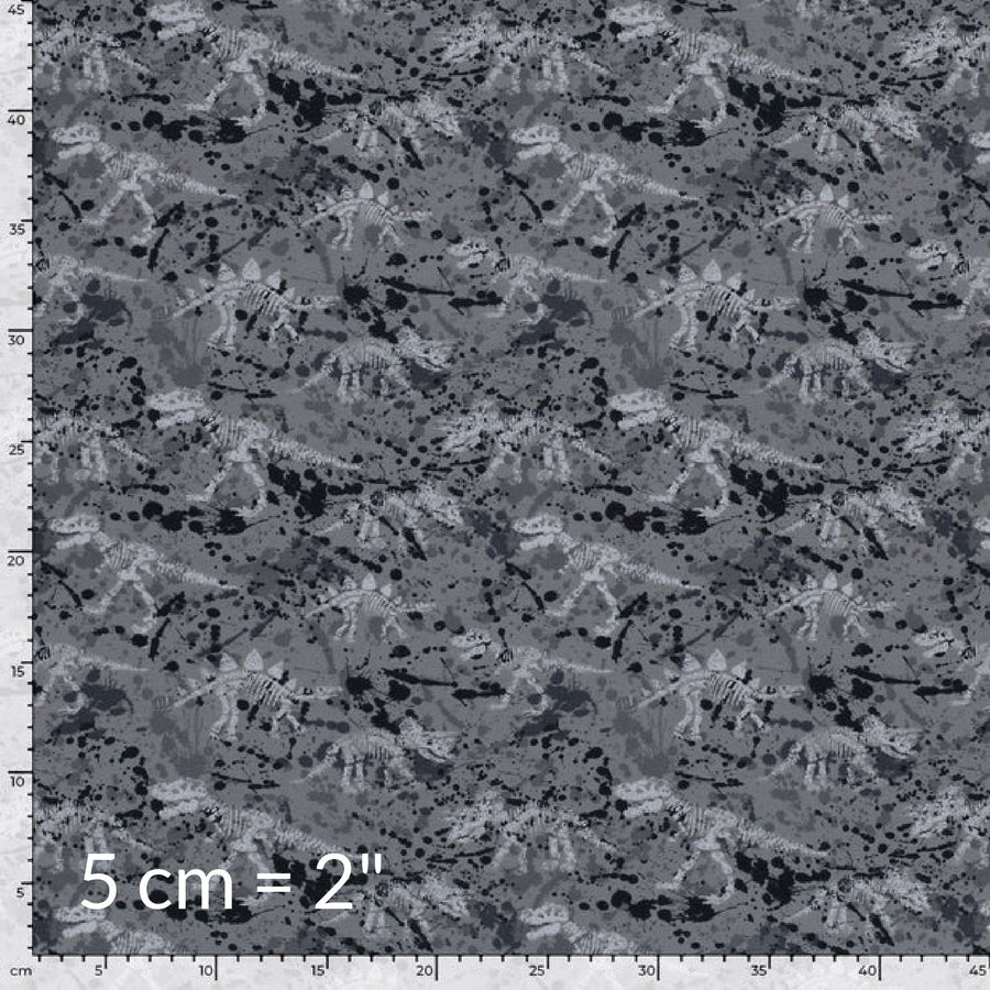 Printed fabric swatch in shades of grey showing various dinosaur skeletons and a ruler for scale