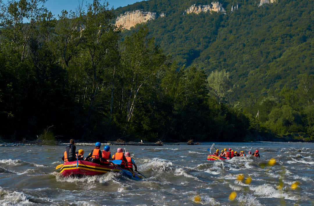 Two rafts heading downstream in easy whitewater