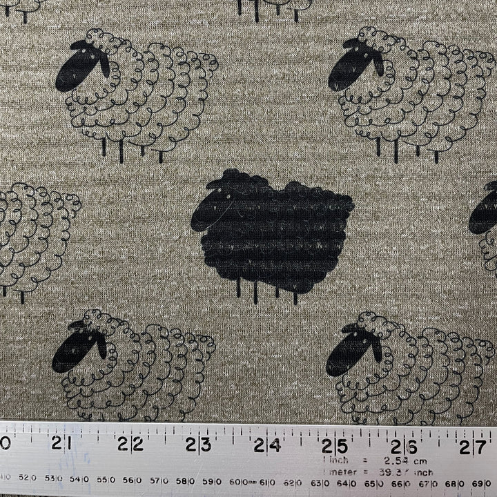 Close up of polartec power wool lightweight in heather grey green with a cute print of cartoon wooly sheep