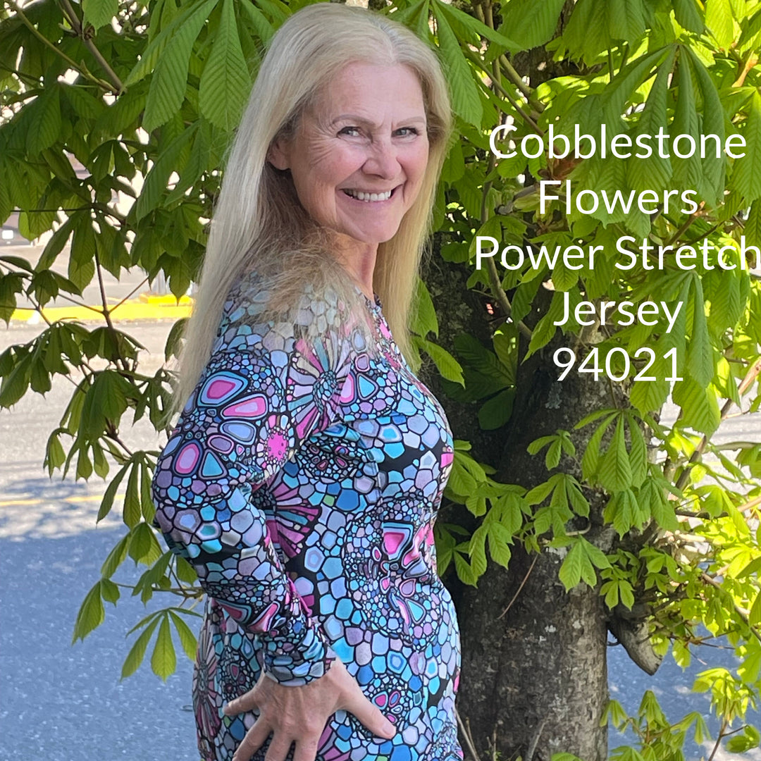 a woman wearing a long sleeved crew neck shirt made from the cobblestone flowers printed power stretch jersey fabric