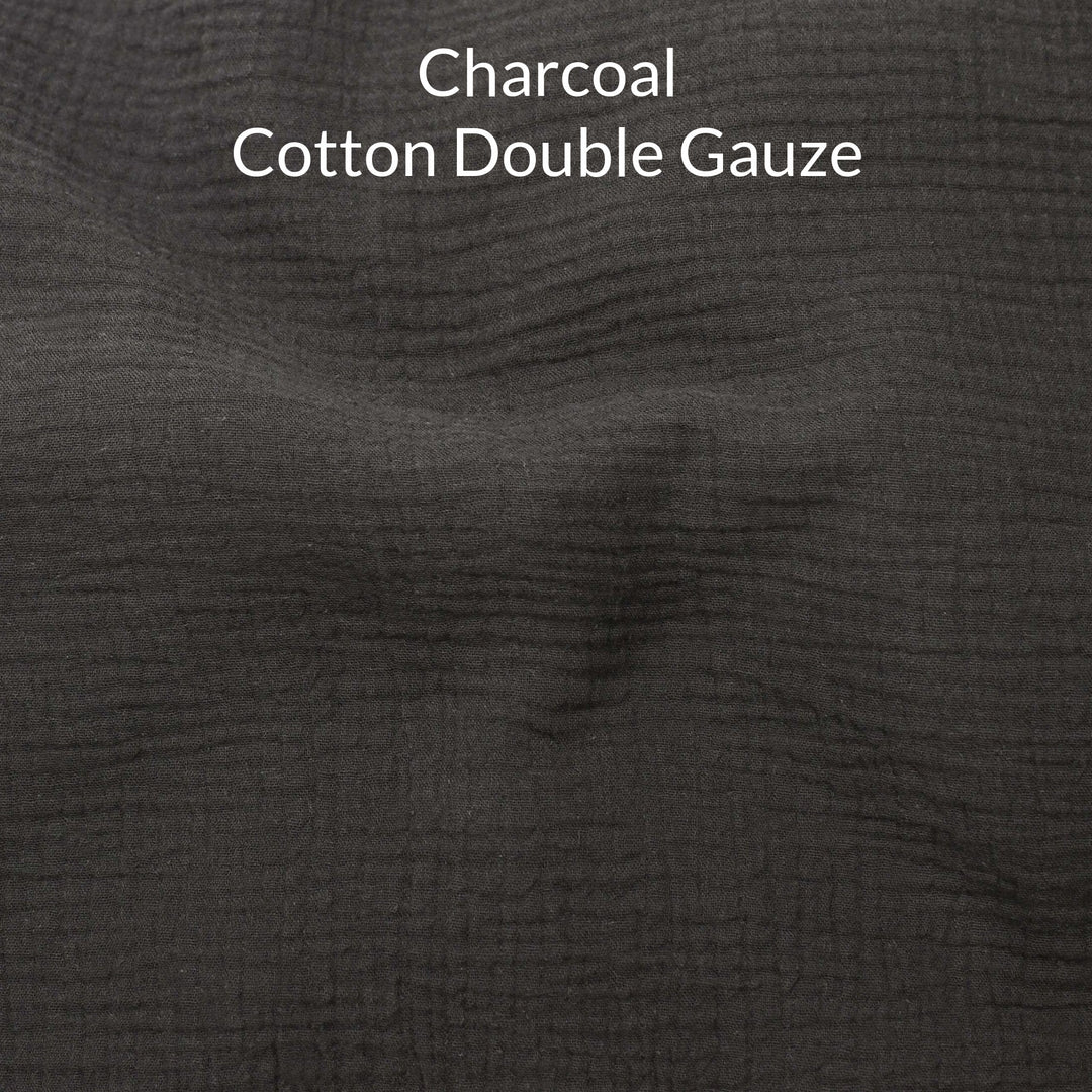 Close-up of dark charcoal-colored cotton double gauze fabric with text overlay.