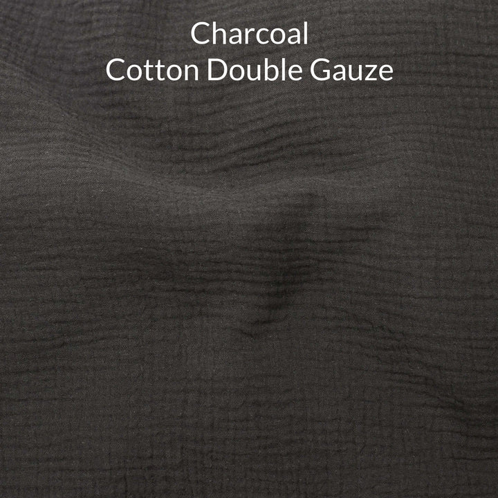Close-up of dark charcoal-colored cotton double gauze fabric with text overlay.