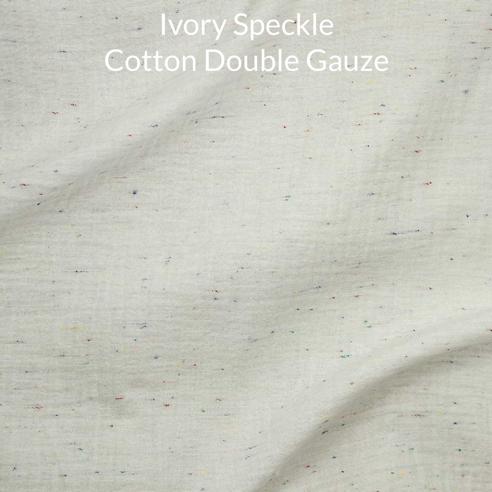 Ivory speckle cotton double gauze fabric with text overlay