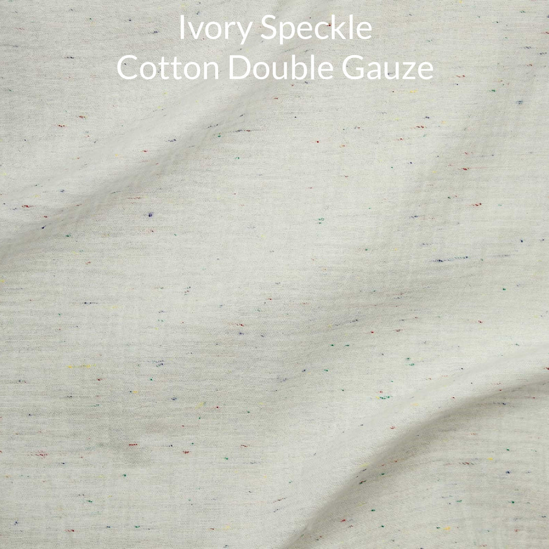 Ivory speckle cotton double gauze fabric with text overlay