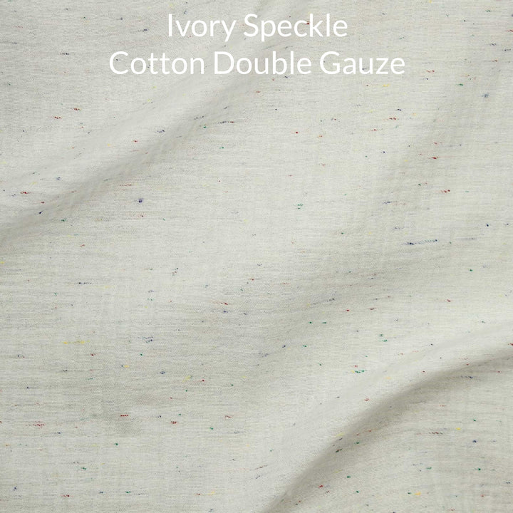 Ivory speckle cotton double gauze fabric with text overlay