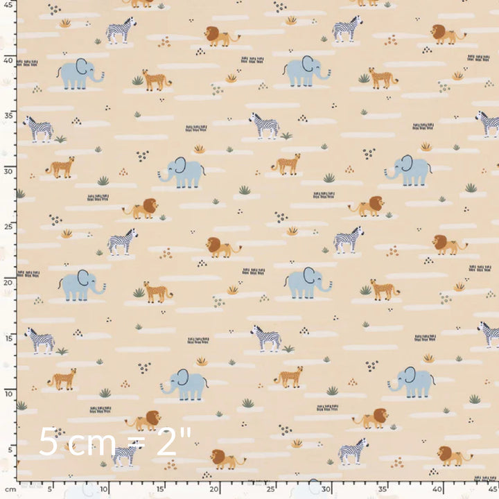 Fabric swatch showing cute children's print of African animals on a warm beige background with ruler for scale