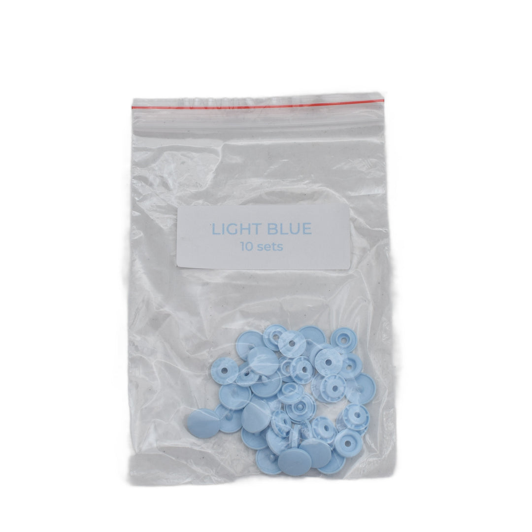 A clear plastic zip-top bag labeled 'LIGHT BLUE 10 sets' containing small light blue size T5 circular plastic snap components, shown on a plain white background.