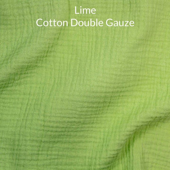 Close-up of lime green cotton double gauze fabric with text overlay.