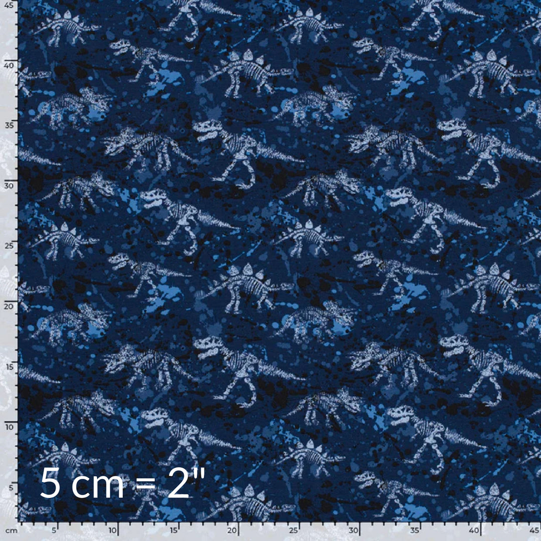 Printed fabric swatch in shades of blue showing various dinosaur skeletons and a ruler for scale