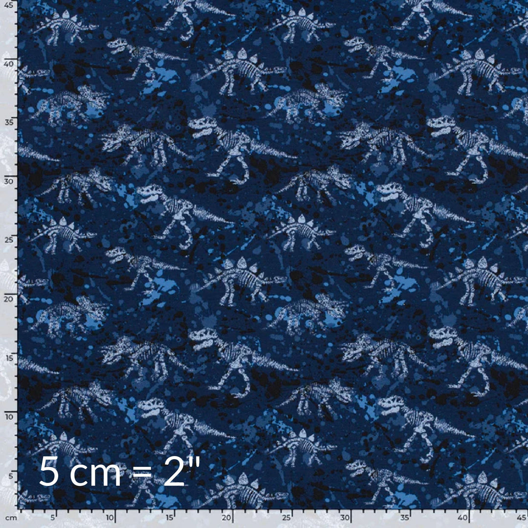 Printed fabric swatch in shades of blue showing various dinosaur skeletons and a ruler for scale