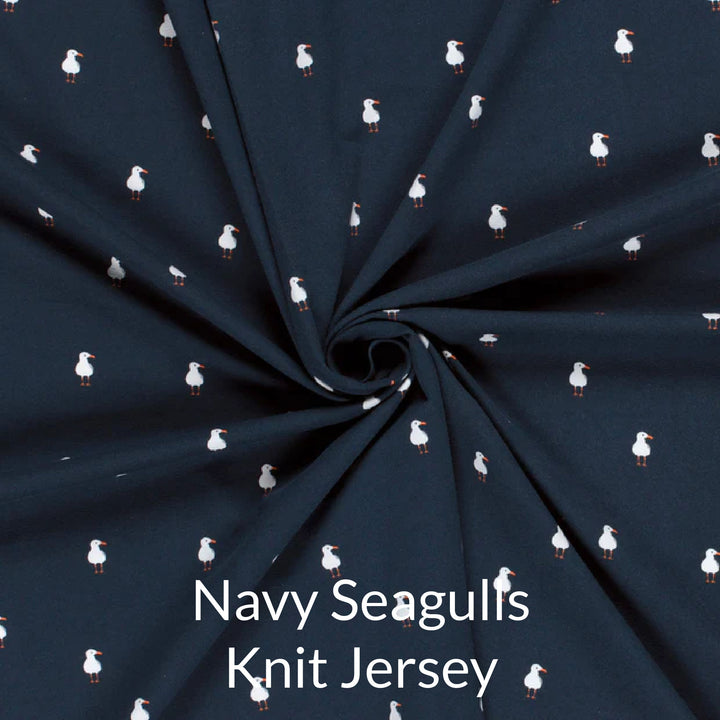 Fabric swatch of cute children's print of white seagulls a navy background