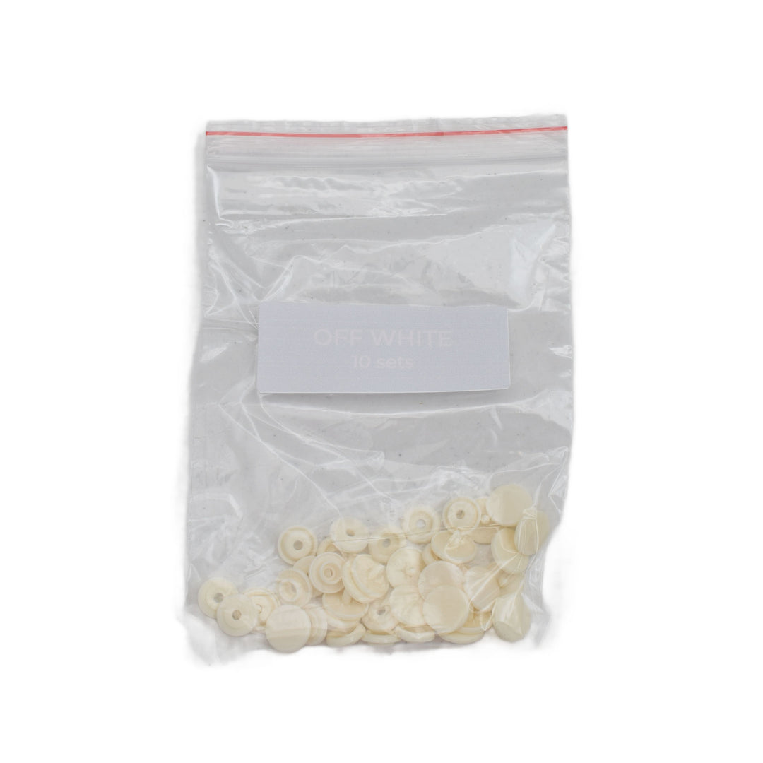 A clear plastic zip-top bag containing off-white size T5 round snaps, with a white label reading 'OFF WHITE 50 pcs' on a plain white background.
