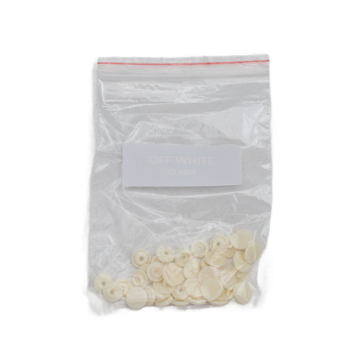 A clear plastic zip-top bag containing off-white size T5 round snaps, with a white label reading 'OFF WHITE 50 pcs' on a plain white background.
