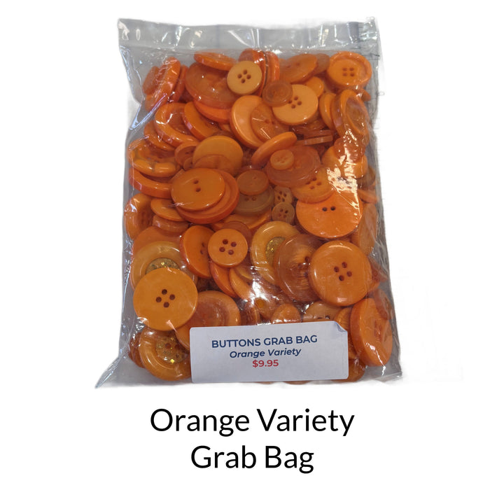 Mixed bag of orange buttons in different sizes and shades