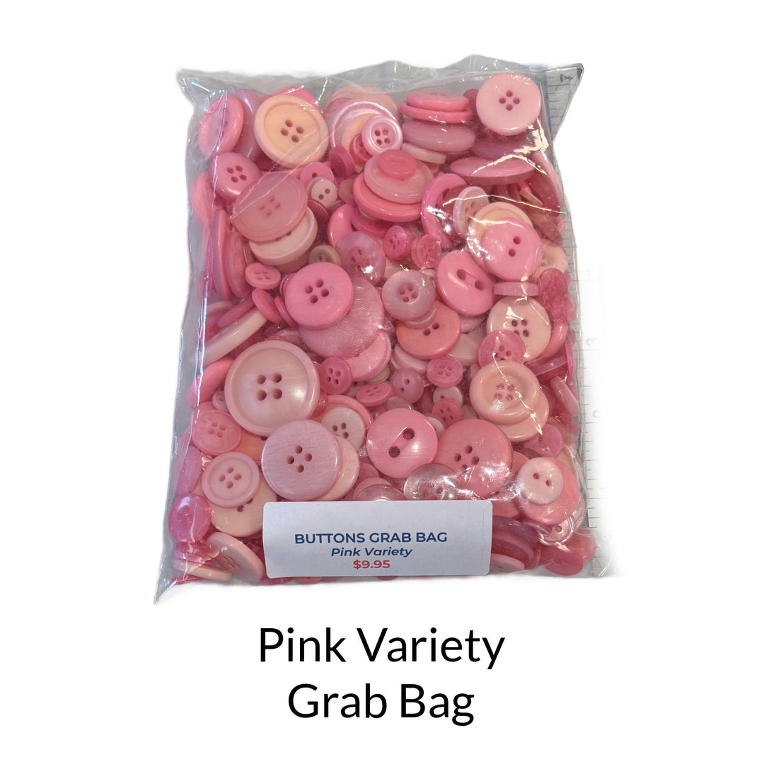 Mixed bag of pink buttons in different sizes and shades of light to medium pink