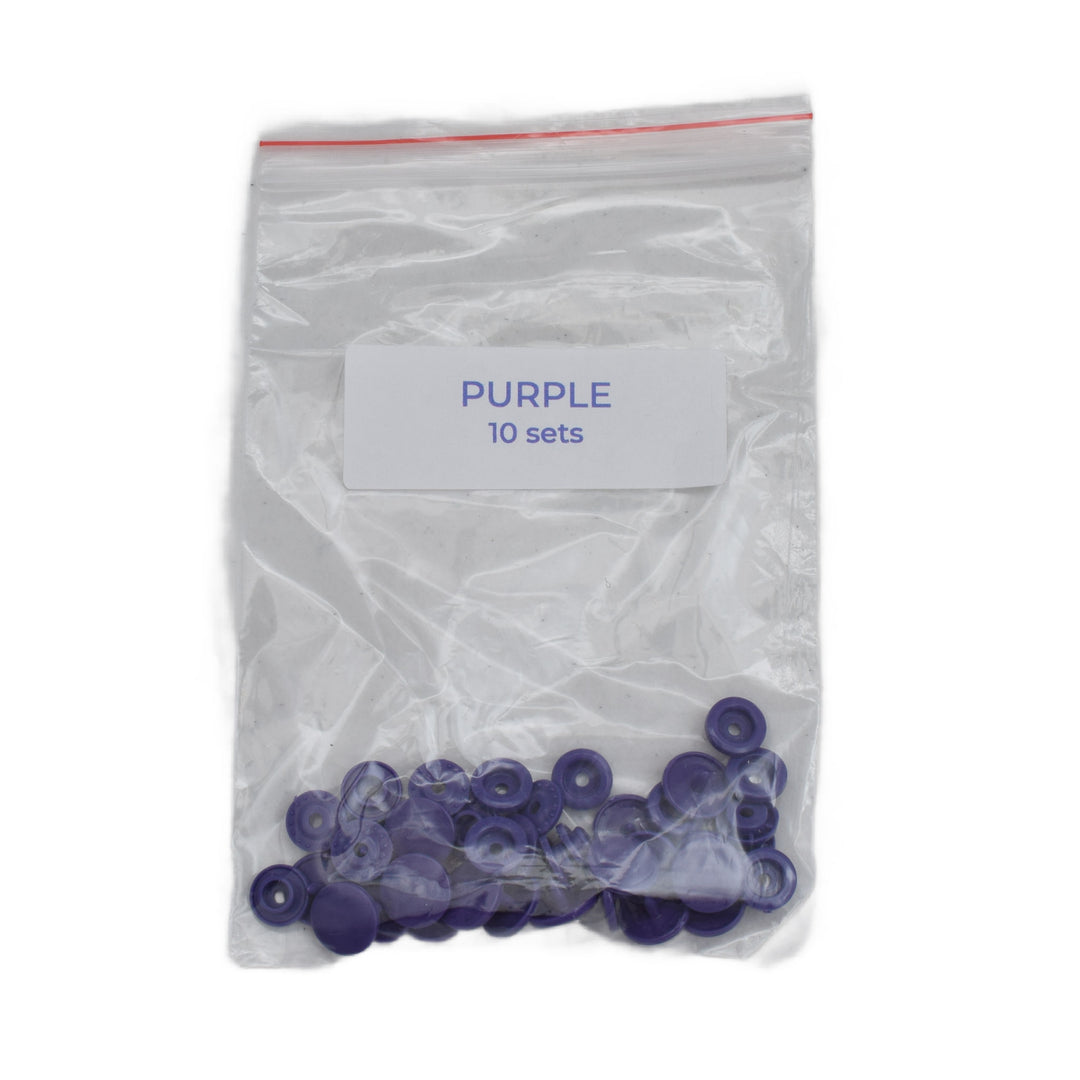 A clear plastic zip-top bag with a white label reading 'PURPLE 10 sets' containing small purple size T5 plastic snap pieces, shown on a white background.