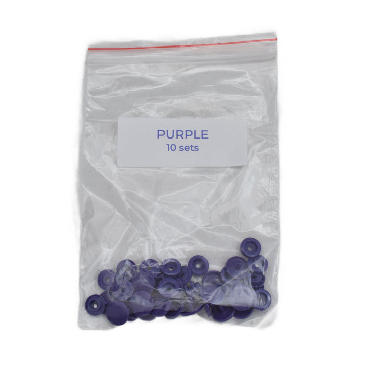 A clear plastic zip-top bag with a white label reading 'PURPLE 10 sets' containing small purple size T5 plastic snap pieces, shown on a white background.