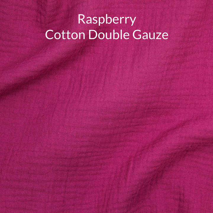 Close-up of raspberry dark pink-colored cotton double gauze fabric with text overlay.