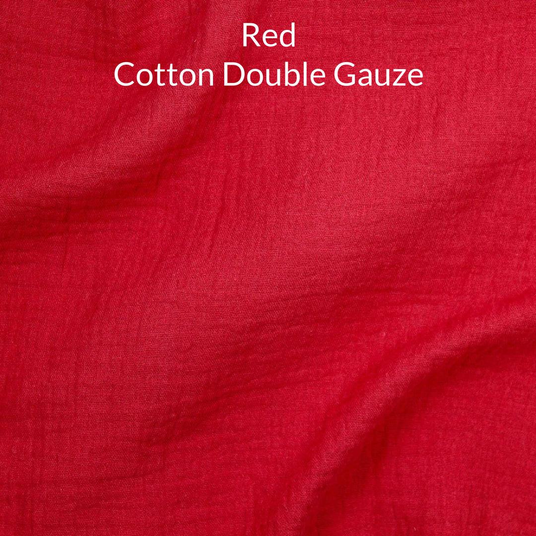 Close-up of red-colored cotton double gauze fabric with text overlay.