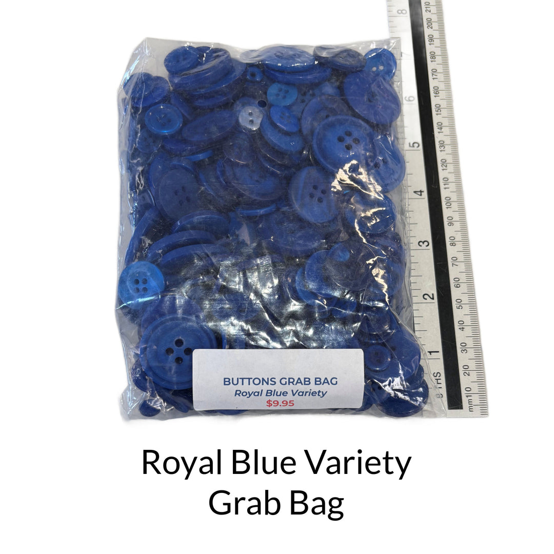 Bag of blue buttons with a ruler for scale on a white background