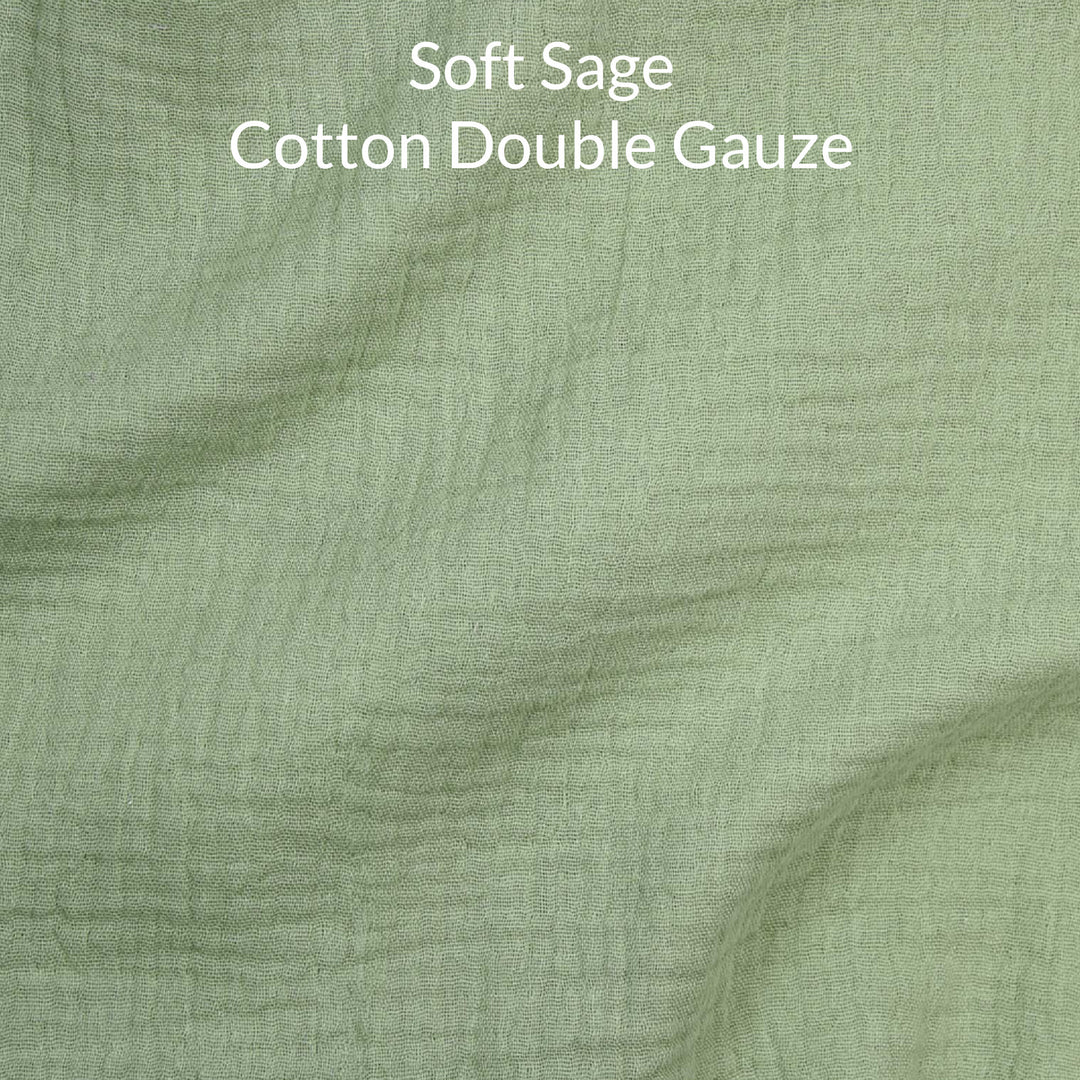 Close-up of soft sage green-colored cotton double gauze fabric with text overlay.