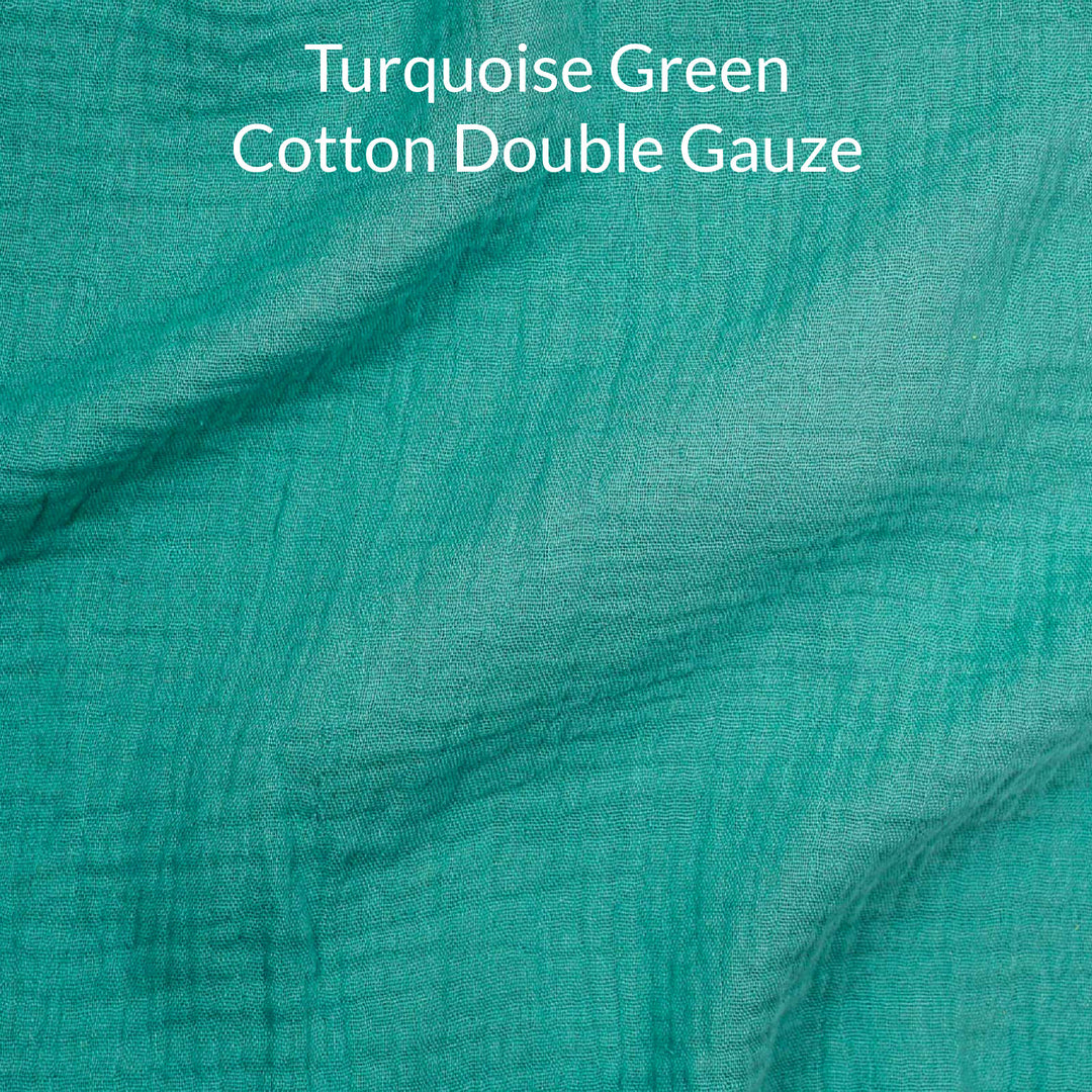 Turquoise green cotton double gauze fabric with text overlay