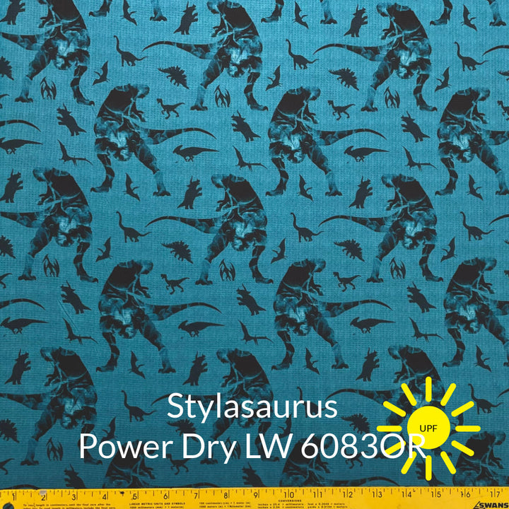 large and small black and grey tone dinosaurs are soft teal background polartec power dry lightweight