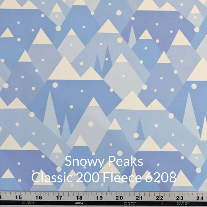 Shade of blue peaked mountains with white tops and round snowflakes classic 200 fleece