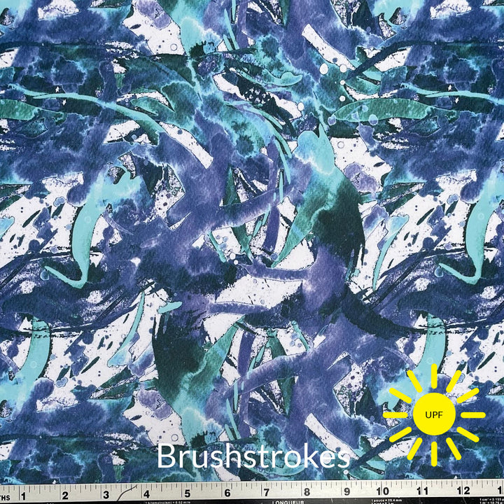 blue and greens shaded brush strokes on white backgroud of breathe tek athletic fabric