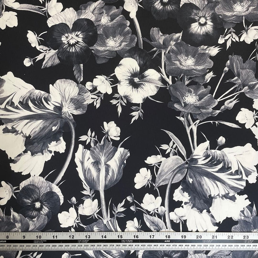 White and shades of grey flower print on black background polartec power shield pro print fabric