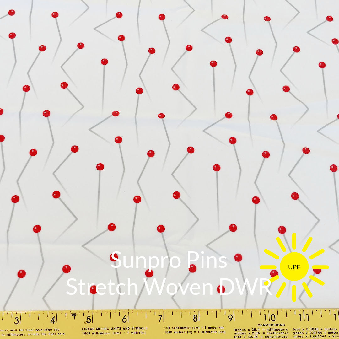 red and pale grey silver crooked push pins on white background sun pro sun protection stretch woven fabric