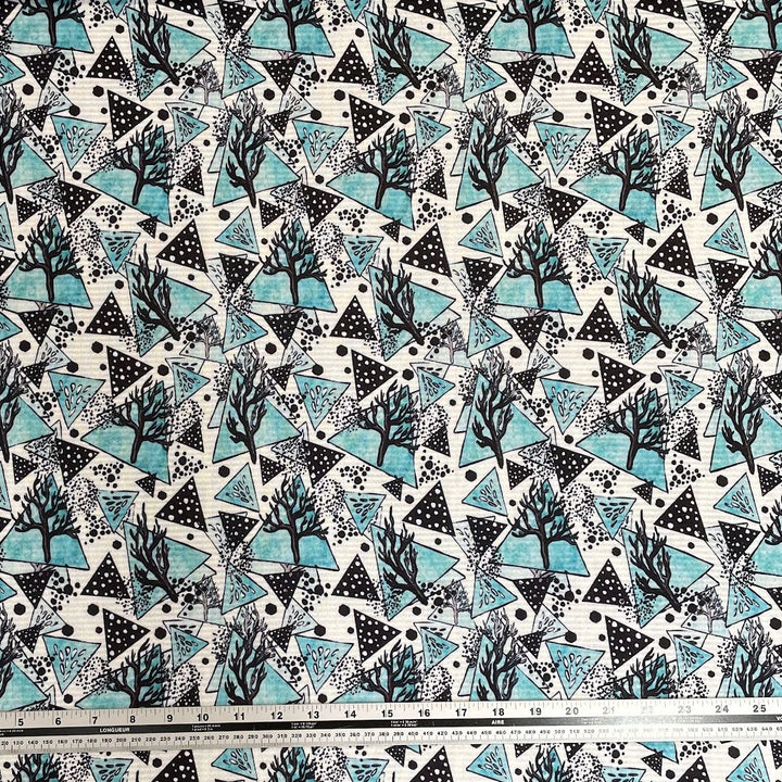 Turquoise and Black triangles and trees on white background polartec power grid mid warmth print fabric